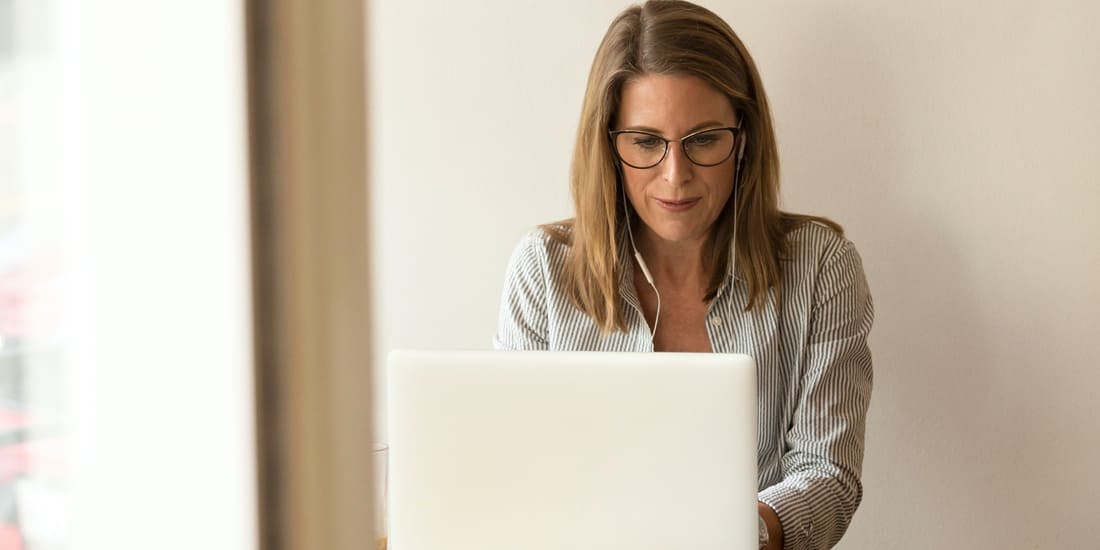 Person sitting at desk with a laptop