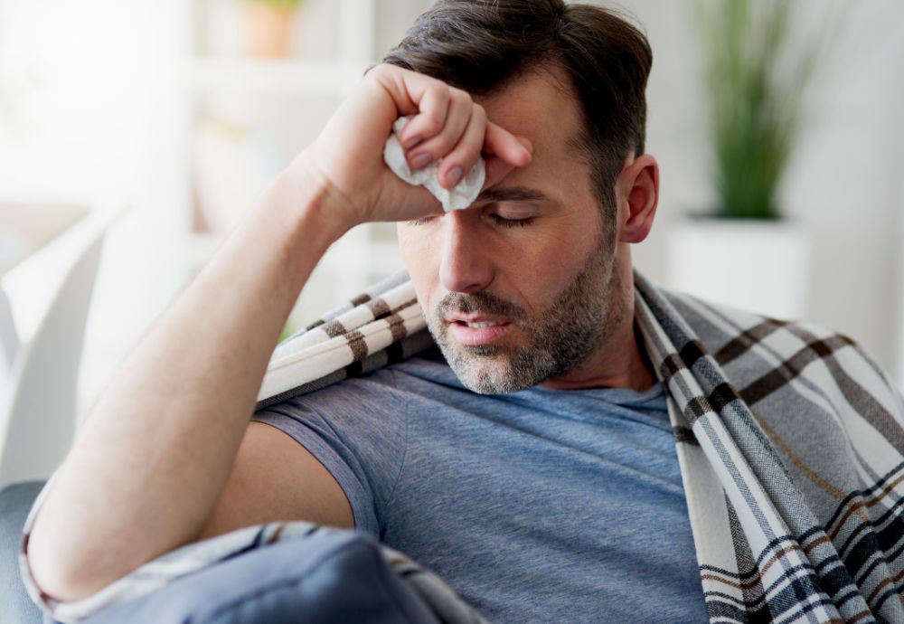 A man visibly ill getting sick pay