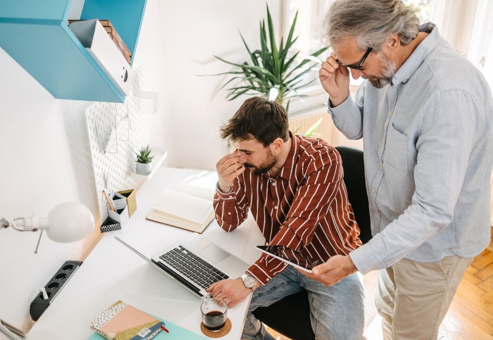 A boss Micromanaging an employee watching him work