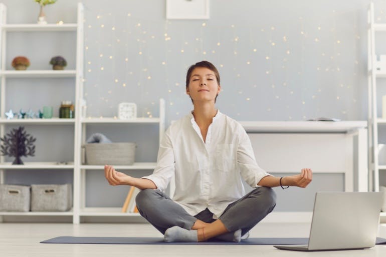 Employee meditating looking after their mental health