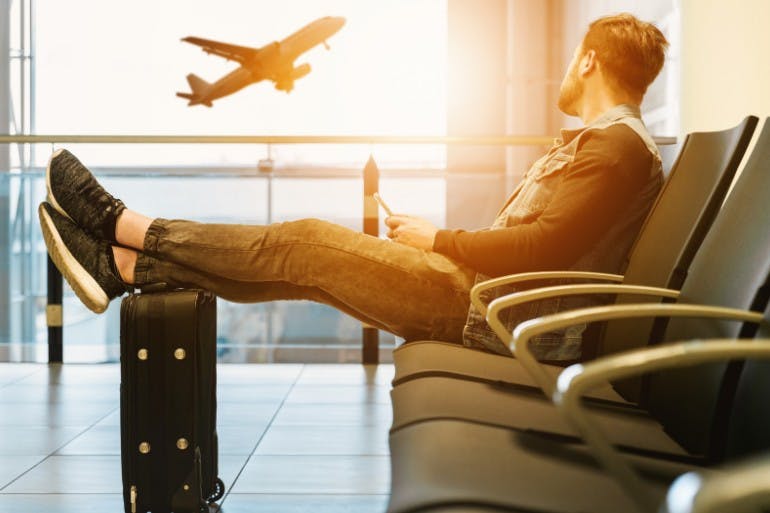 Male employee waiting for a flight at the airport