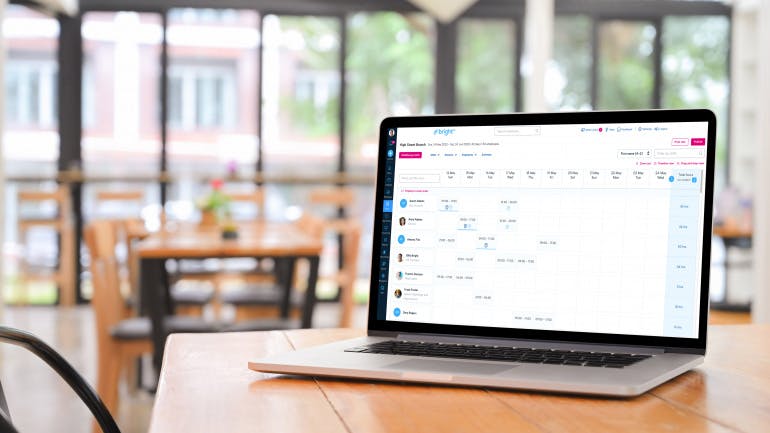 BrightHR's shift and rota planning software on a laptop screen in a coffee shop