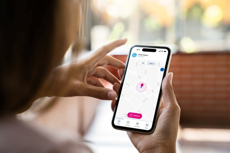 woman using clock in and out app, Blip on mobile phone